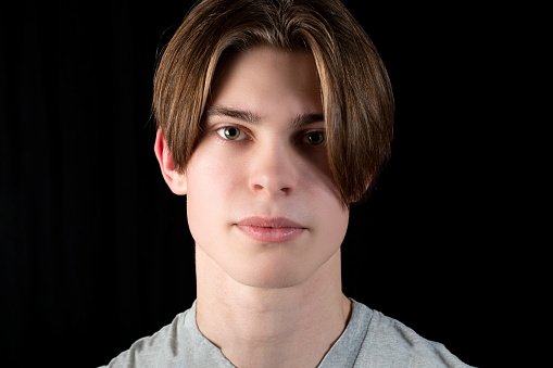 Portrait of a young man on a black background.Studio photo.