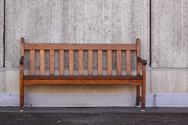 istock a wooden bench sitting in front of a building 1456606238