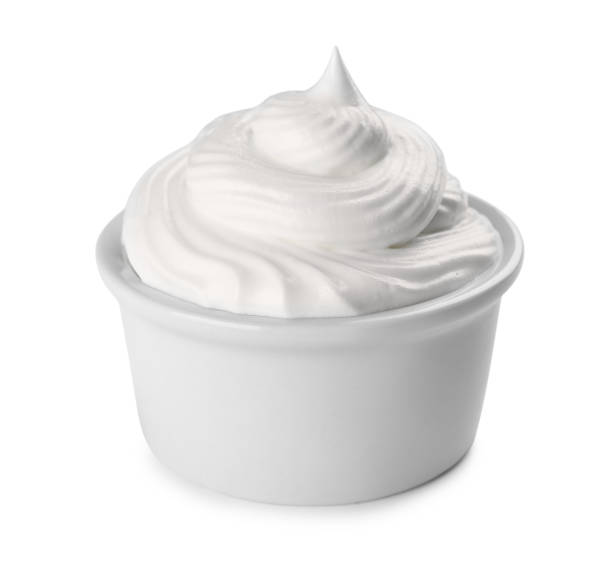 istock Fresh whipped cream in bowl isolated on white 1456606666