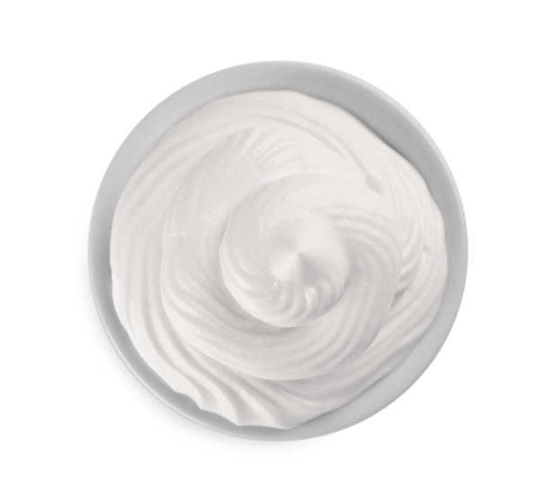 istock Fresh whipped cream in bowl isolated on white, top view 1456606670