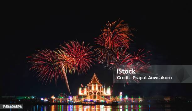 Beautiful Fireworks On Night Sky Over Wat Krok Krak Thai Temple With Decorative Lighting And Light Reflection On River Surface In Annual Festival Area At Night Stock Photo - Download Image Now