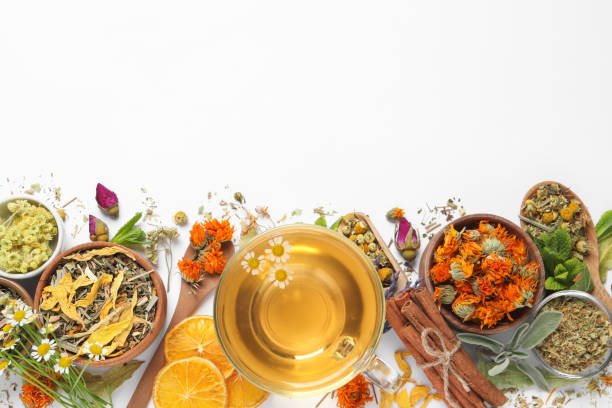 istock Freshly brewed tea and dried herbs on white background, top view. Space for text 1456606917