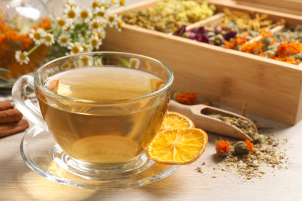 istock Freshly brewed tea and dried herbs on white wooden table, closeup 1456606949