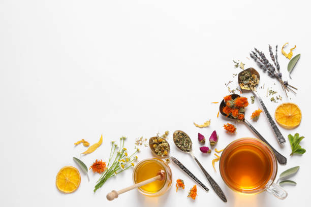 istock Freshly brewed tea and dried herbs on white background, top view. Space for text 1456606953