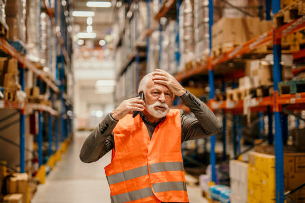 istock Displeased warehouse manager on phone 1456606973