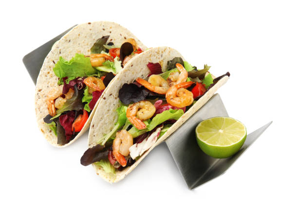 istock Delicious tacos with shrimps and lime on white background 1456606979