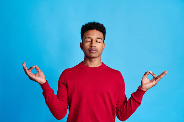 istock Cheerful black man doing meditation exercises 1456607956