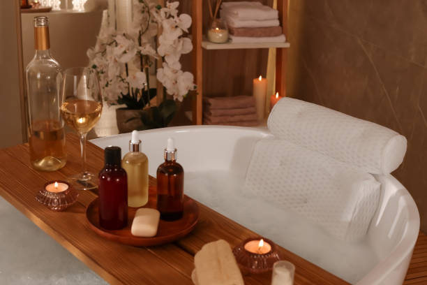 istock Tub with soft bath pillow, toiletries and wine indoors 1456608094