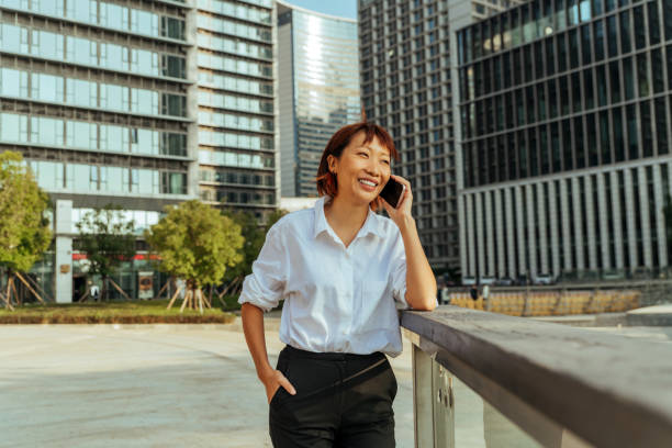 istock Female student talking on the smartphone outdoors. 1456608971