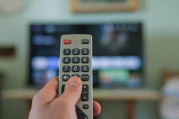 istock Man hand while browse smart tv app,zapping channels on leisure time,tech lifestyle 1456609819