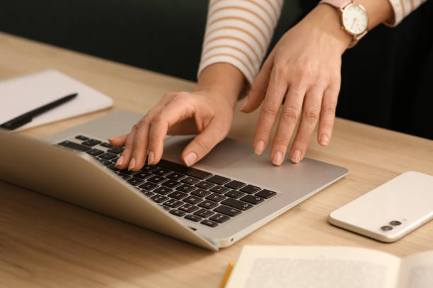 istock Woman with modern laptop learning at table indoors, closeup 1456611395