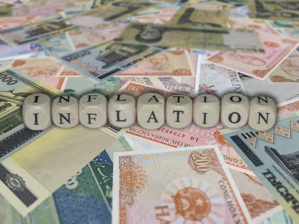 istock Cube block combine word Inflation on a world banknotes background 1456611533