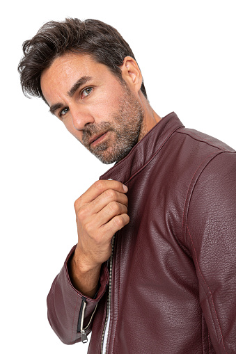 Handsome middle-aged hispanic stubby bearded man on white studio. Short-haired handsome man in leather jacket and t-shirt, on white background.