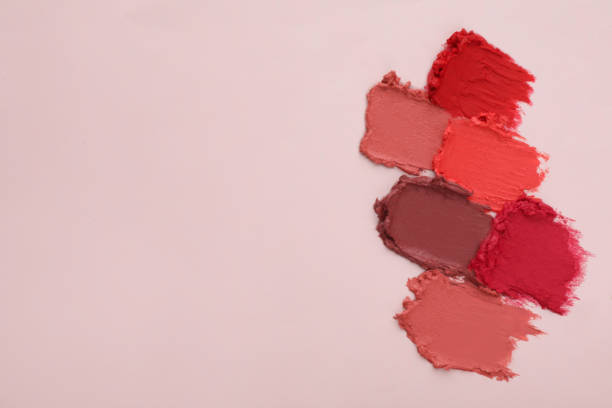 istock Smears of different beautiful lipsticks on light background, top view. Space for text 1456613178
