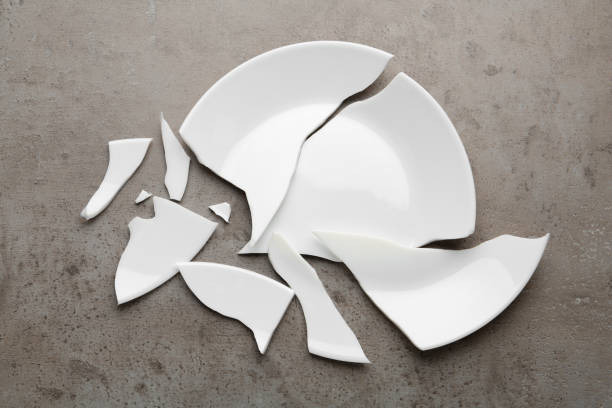 istock Pieces of broken ceramic plate on grey table, flat lay 1456613422