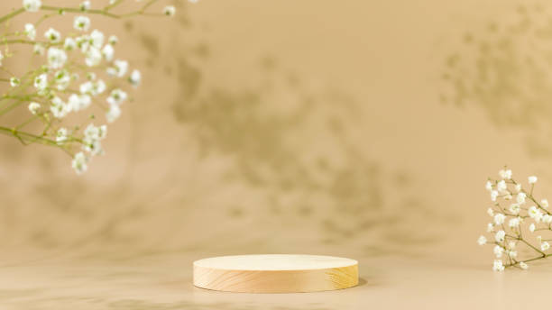 istock Wooden empty podium on beige background with white flowers 1456613503
