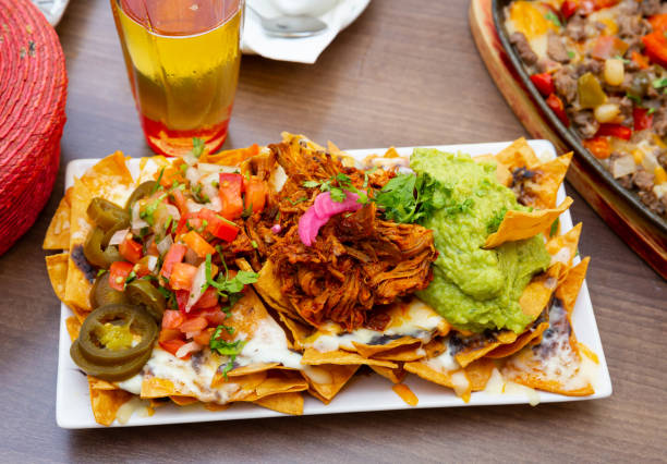 istock Corn chips nachos with homemade guacamole sauce, meat, cheese 1456614714