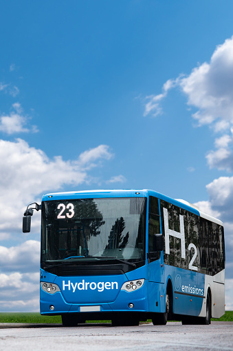Blue fuel cell bus with inscription HYDROGEN on a board