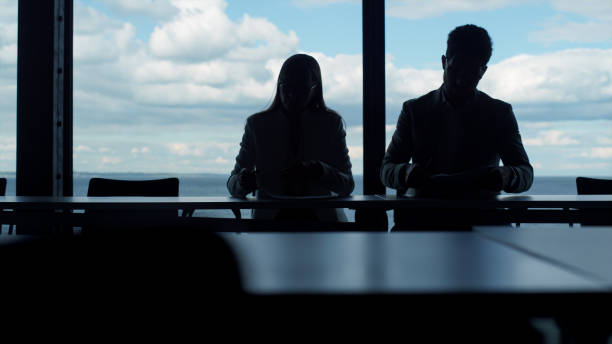 istock Coworkers silhouettes working office at panorama window. Business team checking 1456619575