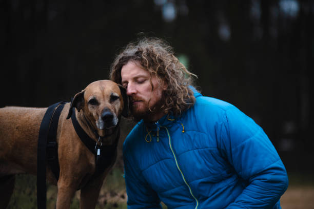 istock Man on a winter hike with a dog 1456619598