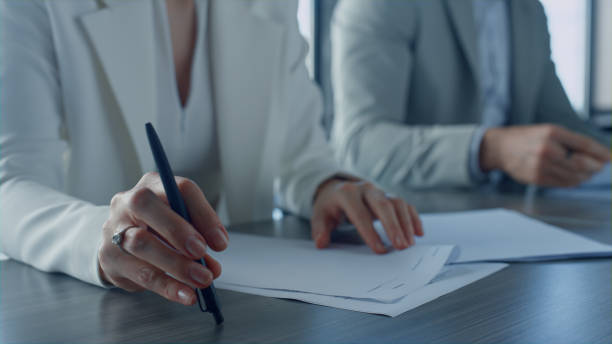 istock Closeup hands checking papers on corporate meeting. Business partners exchanging 1456619903