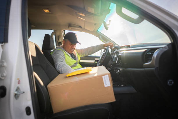 istock Mature delivery man checking orders while preparing the products to customer 1456619904