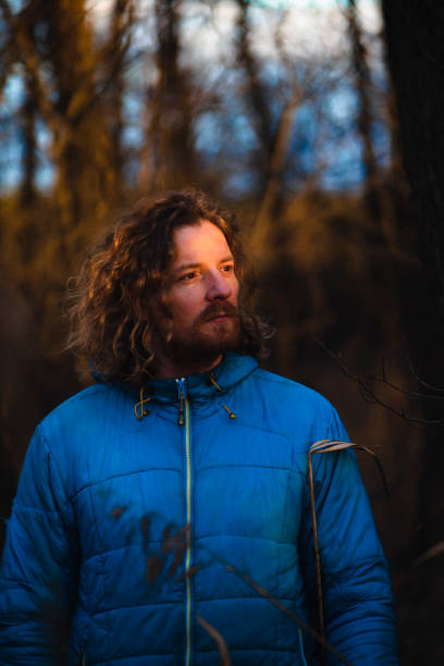 istock Blond man with curly hair in an winter afternoon sun 1456619952