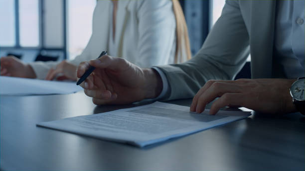 istock Hand holding pen checking document closeup. Employee reading contract details 1456620677