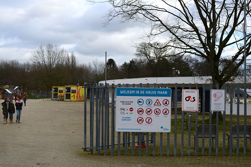 Diest, Flemish-Brabant, Belgium - January 15, 2023: welcome to domain half moon. Families, 2 mothers 3 white girls ages 8, 10 and 11 years leaving outdoors public swimming pool recreational domain
