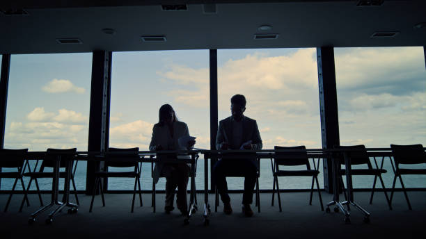 istock Partners silhouettes signing contract at panorama window. Business team analyze 1456620787