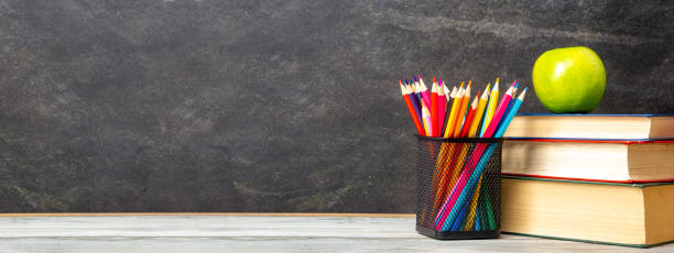 istock Back to school concept. School supplies on black board background. 1456622150