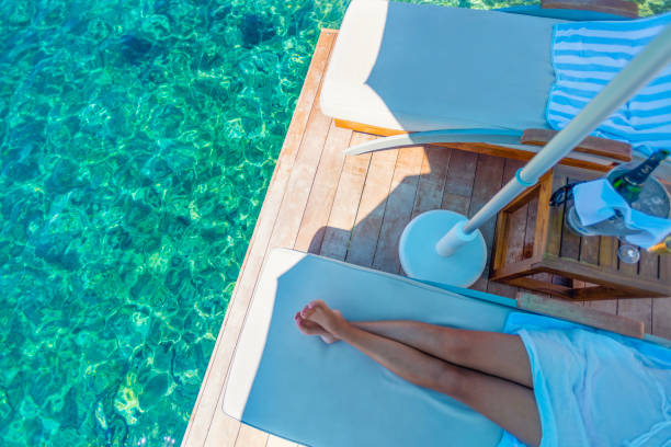 istock Woman on a sun lounge at the beach. 1456623406