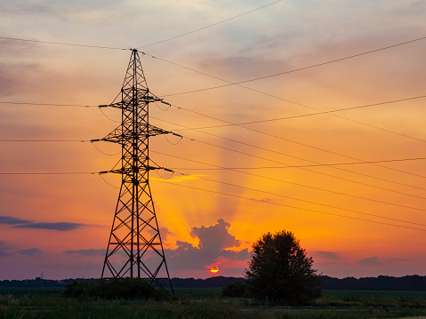Power lines at the sunset. Electricity distribution grid