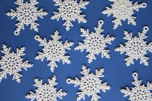 istock Snowflakes on a blue background. Winter background. 1456625503