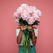 istock Beautiful emotional woman holding bouquet of flowers 1456626236
