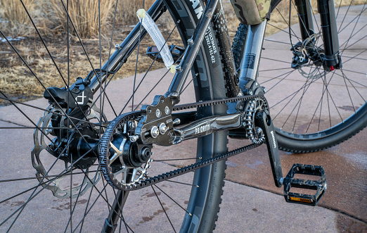 Fort Collins, CO, USA - January 10, 2023: Carbon fiber-reinforced drive belt and  an enclosed Pinion gearbox on the 600x Priority adventure mountain bike.