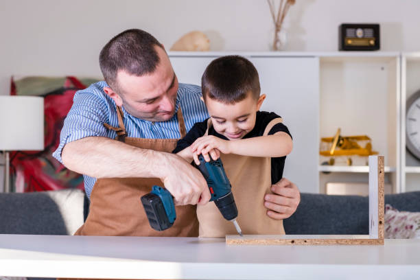 istock Father and son assembling furniture at the table 1456627309