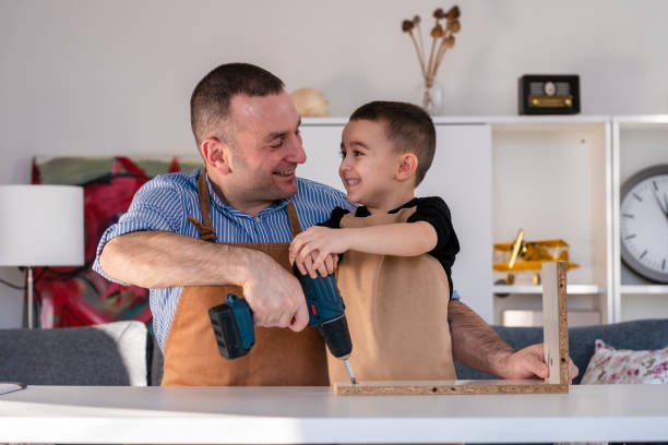 istock Father and son assembling furniture at the table 1456627334