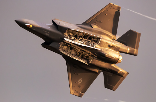 US Air Force Lockheed Martin F-35 Lightning II stealth multirole combat aircraft with open bomb bays flying during the Sanicole Evening Air Show. Sanicole, Belgium - September 10, 2022