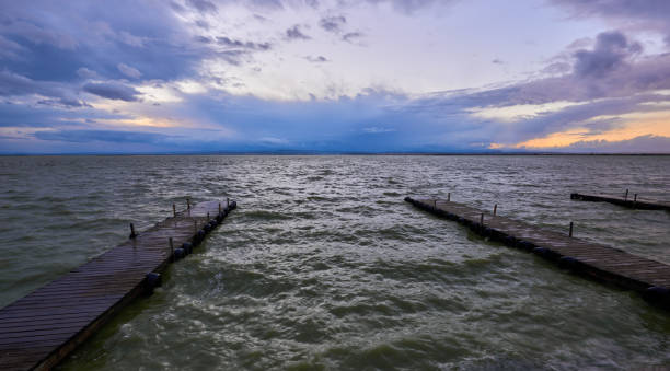 istock A sunset on a lonely pier on a cloudy day 1456629687