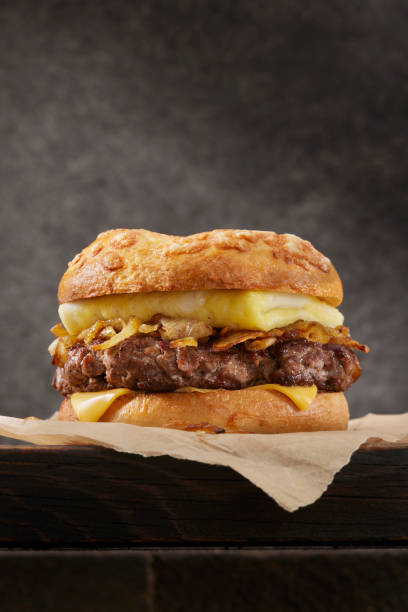Copycat Cheesy Steak and Egg Breakfast Bagel Copycat Cheesy Chopped Top Sirloin Steak Patty and Egg Breakfast Bagel with Fried Onions burger close up stock pictures, royalty-free photos & images