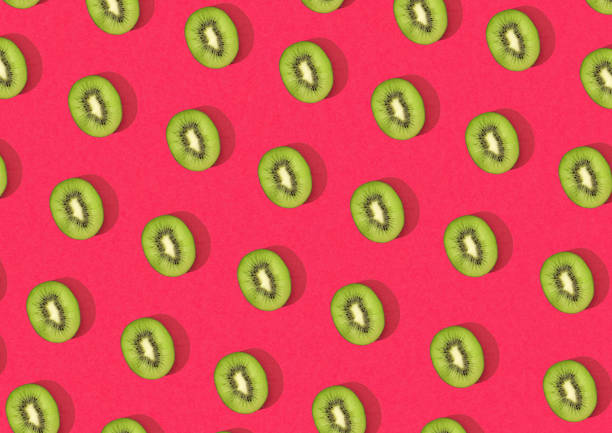 istock Halved kiwi fruits in mesh pattern over red background 1456631665