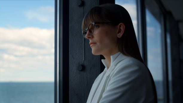 istock Serious woman looking window in suit closeup. Thinking manager making decision 1456633876