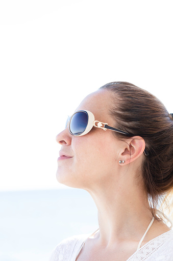 Caucasian female is wearing sunglasses.