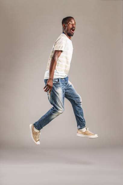 Portrait Of A Confident Man Jumping In The Studio