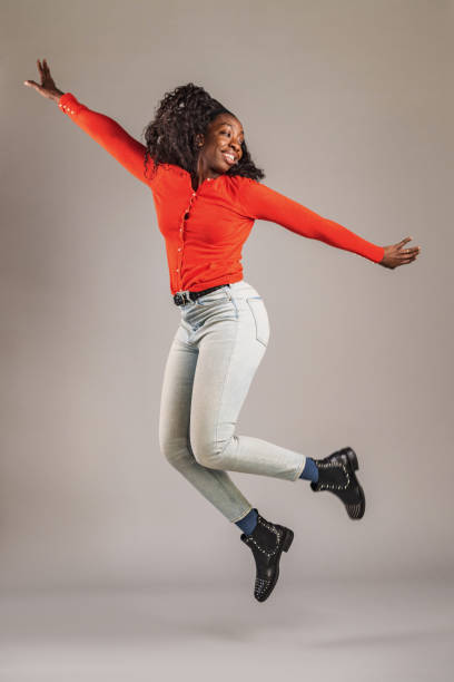 istock Happy and Confident Woman Jumping In The Studio 1456634716