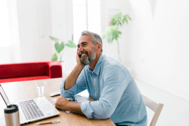 istock Smiling senior businessman working at office 1456635898