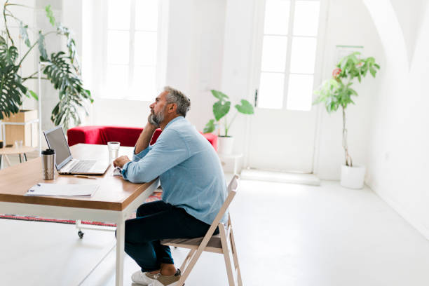 istock Tired businessman working at office 1456637255