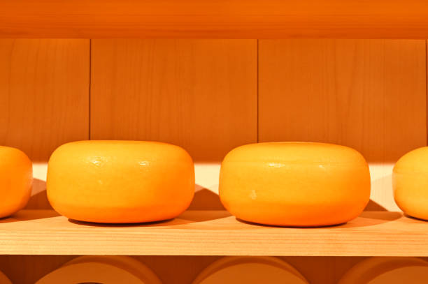 istock Large round mature Edam cheese on a wooden shelf 1456637381