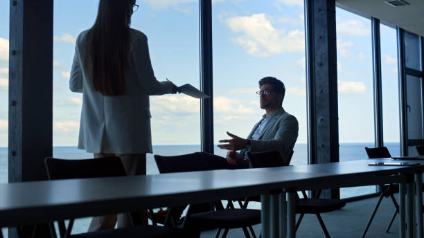 istock Manager showing contract papers to company executive. Thinking businessman rest 1456638783
